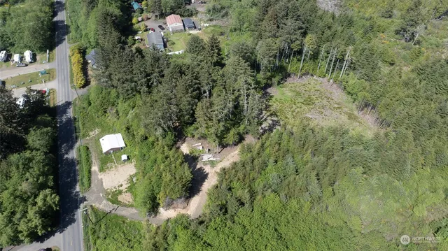 an aerial view of a houses with yard