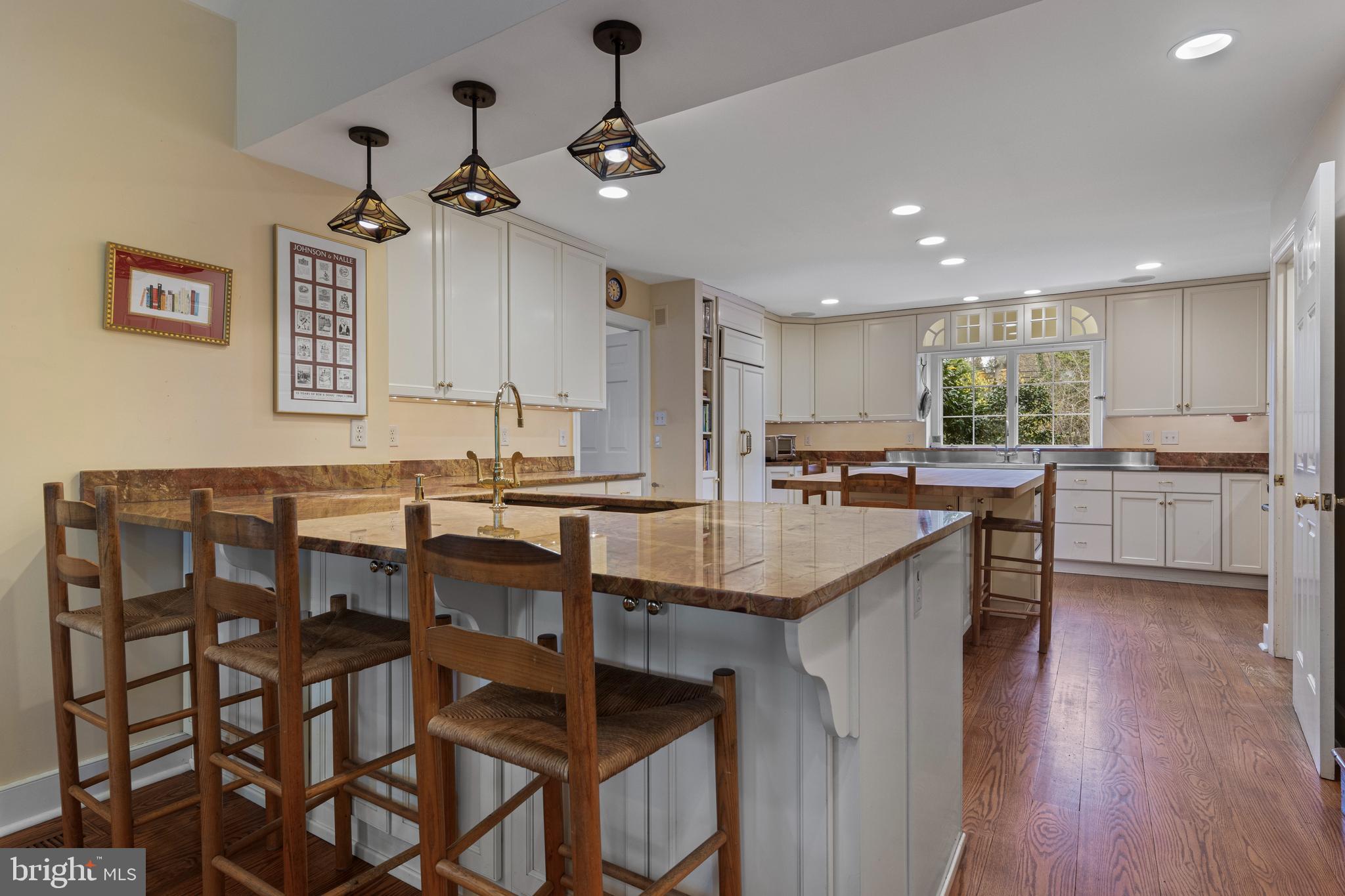 331 Fishers Road Bryn Mawr, PA 19010 - Photo 17 of 64 a kitchen with granite countertop a table chairs stove and cabinets