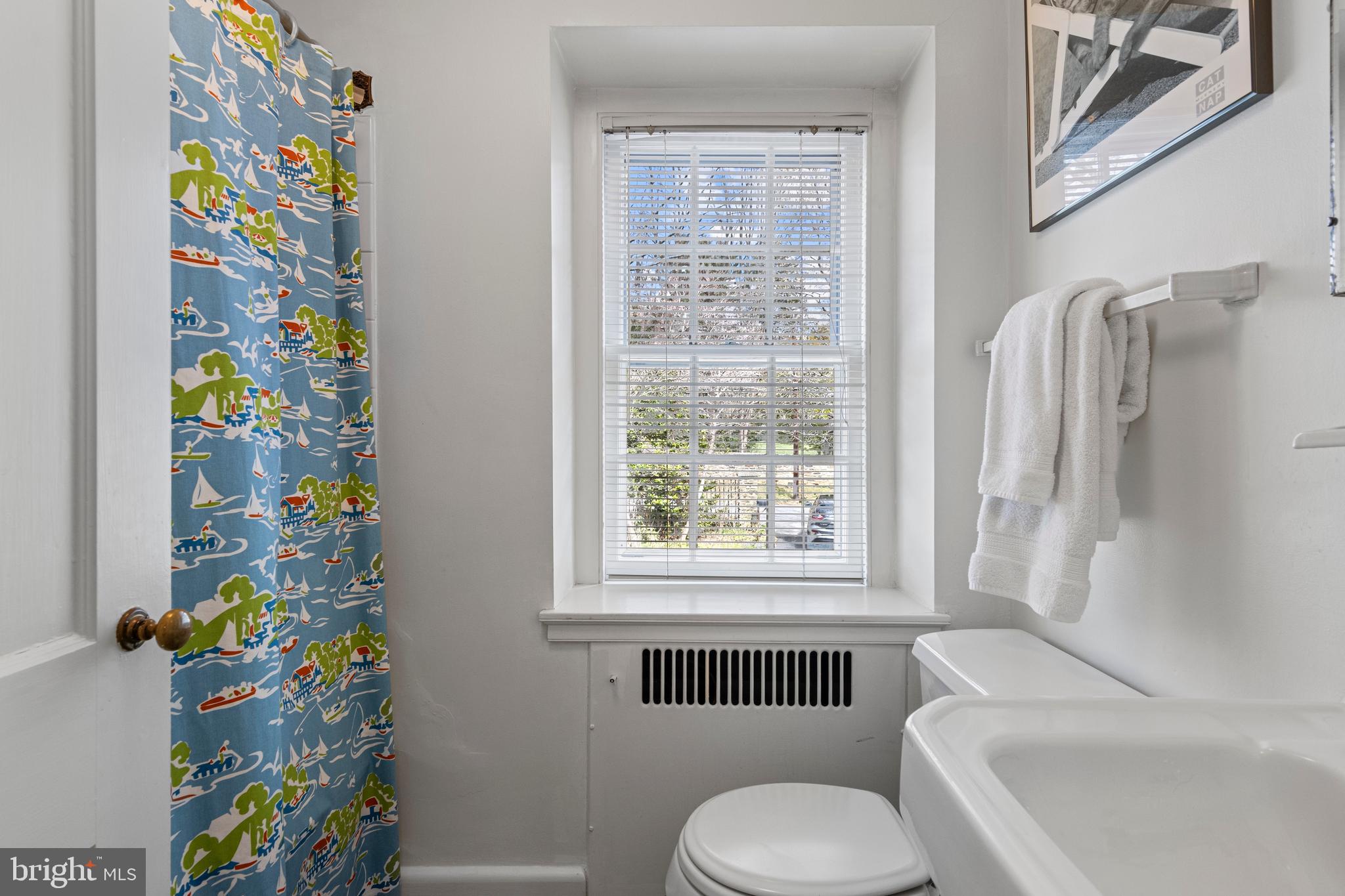 331 Fishers Road Bryn Mawr, PA 19010 - Photo 43 of 64 a bathroom with a toilet and a shower curtain
