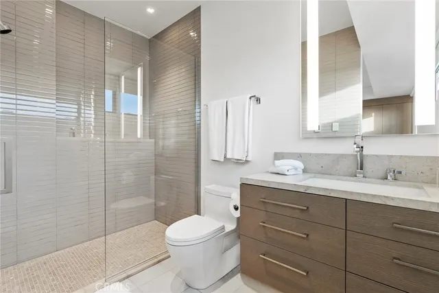 a bathroom with a double vanity sink toilet and shower