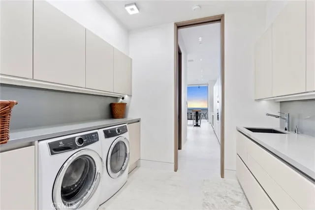 a utility room with sink dryer and washer