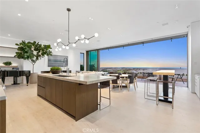 a living room with furniture a chandelier and a dining table