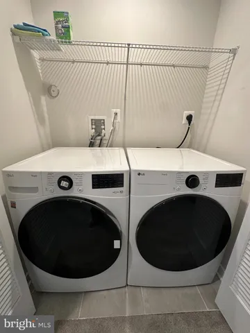 a bathroom with a double vanity sink toilet and shower