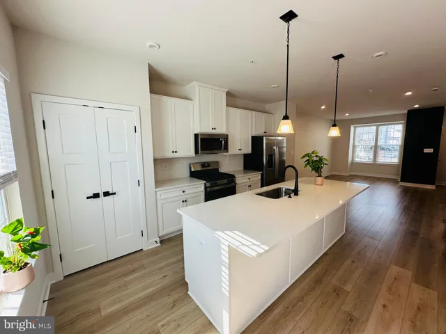 a large kitchen with stainless steel appliances kitchen island a large island in the center
