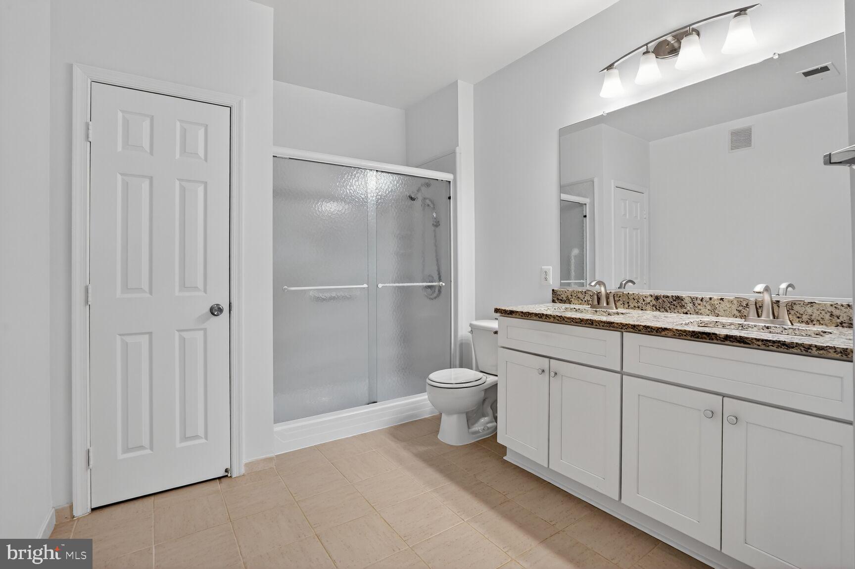 4300 Cannon Ridge Court, Unit 14 Fairfax, VA 22033 - Photo 13 of 23 a bathroom with a granite countertop sink toilet and shower
