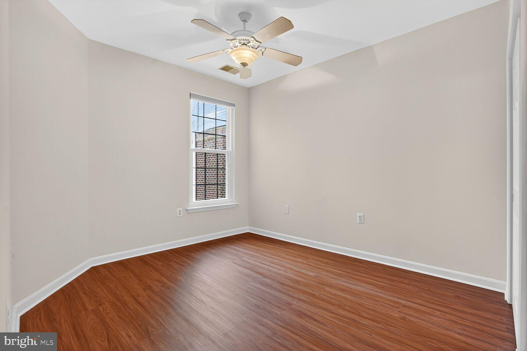 4300 Cannon Ridge Court, Unit 14 Fairfax, VA 22033 - Photo 15 of 23 a view of an empty room with wooden floor and a window