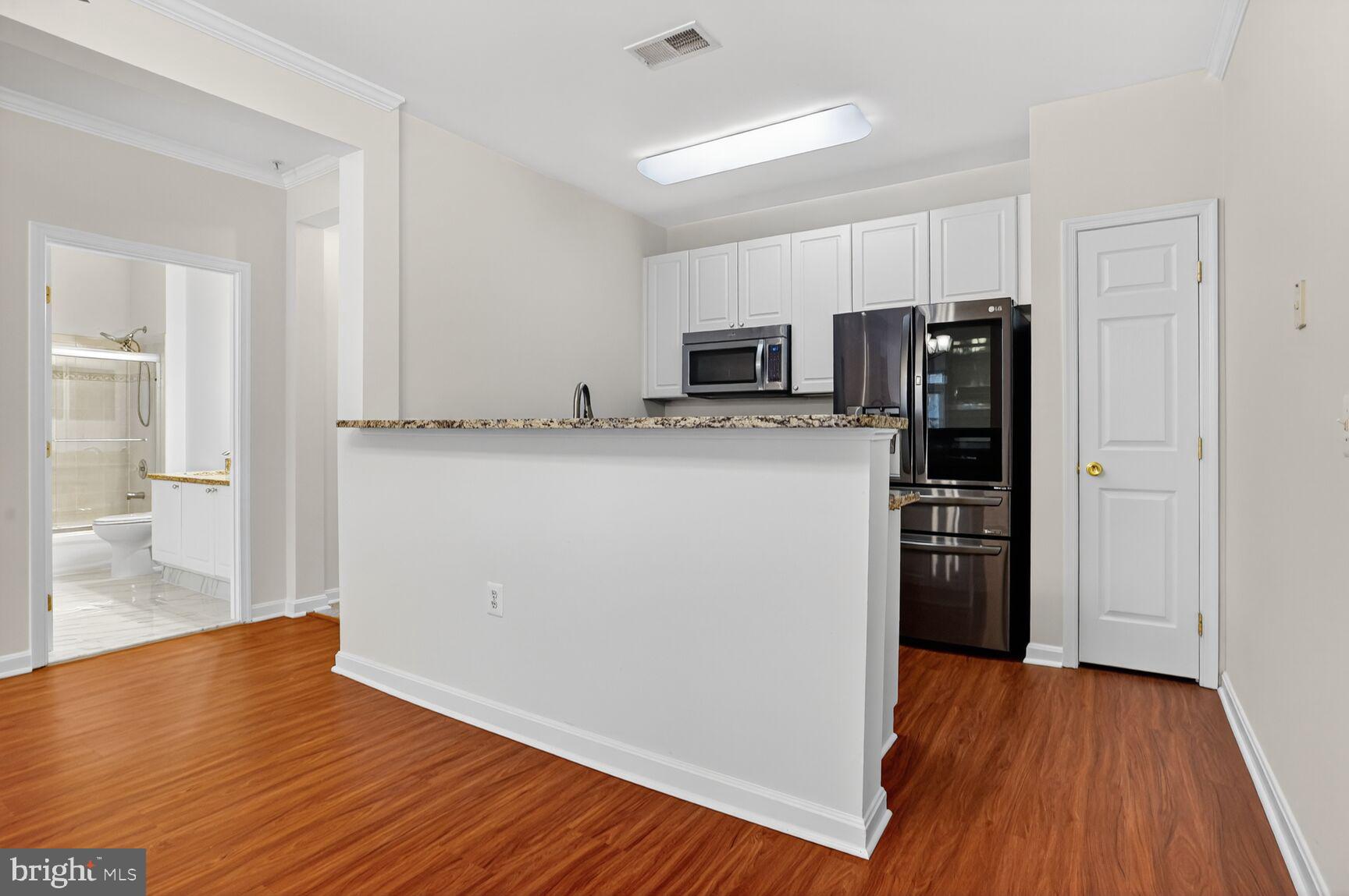 4300 Cannon Ridge Court, Unit 14 Fairfax, VA 22033 - Photo 7 of 23 a kitchen with stainless steel appliances a refrigerator and a stove top oven