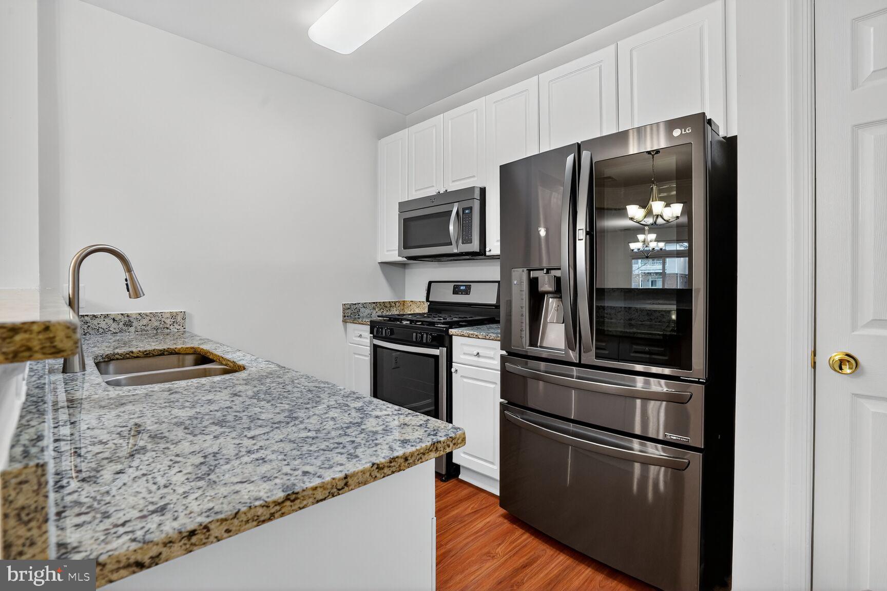 4300 Cannon Ridge Court, Unit 14 Fairfax, VA 22033 - Photo 9 of 23 a kitchen with stainless steel appliances granite countertop a refrigerator and a stove top oven