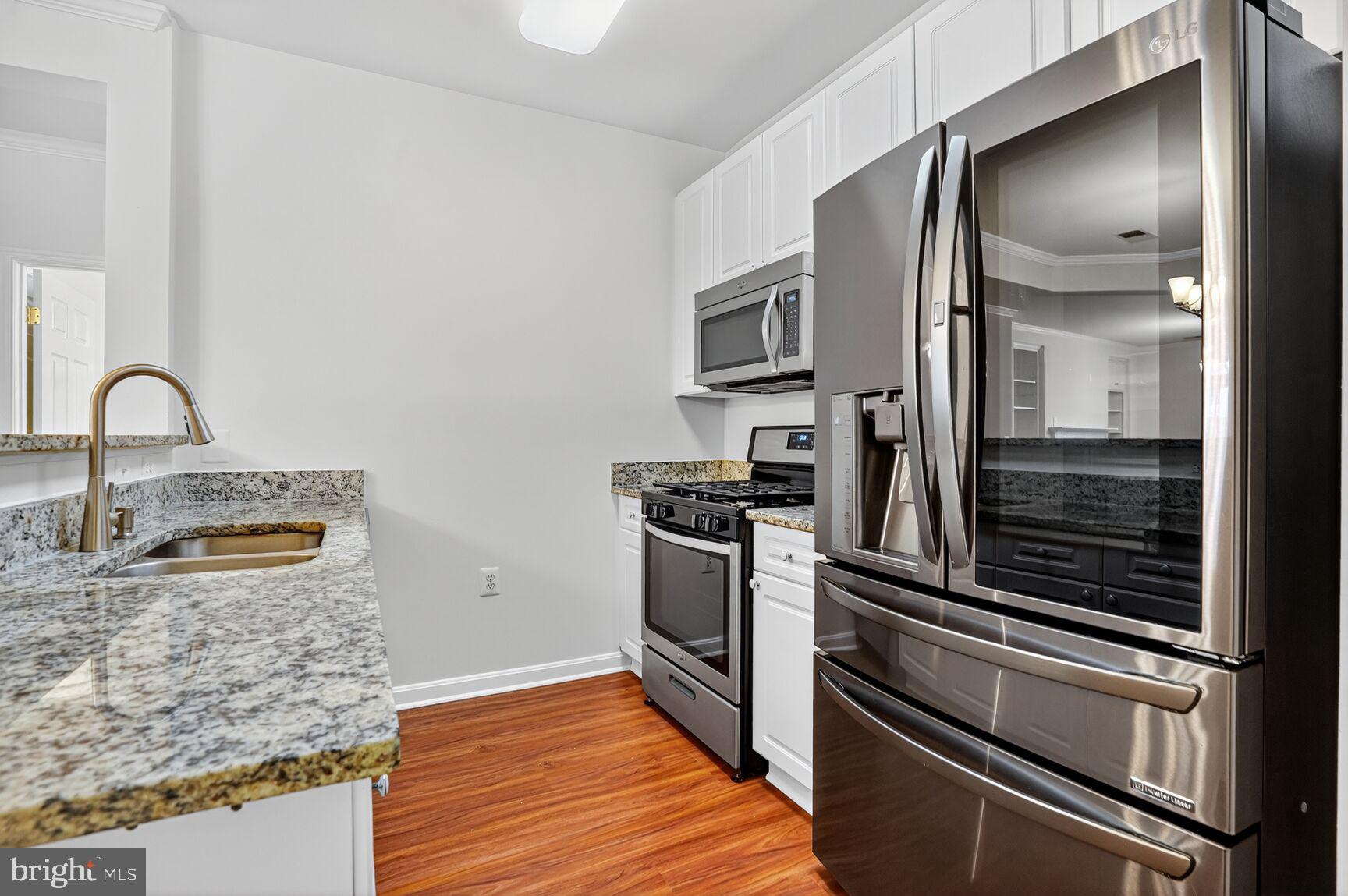 4300 Cannon Ridge Court, Unit 14 Fairfax, VA 22033 - Photo 10 of 23 a kitchen with granite countertop stainless steel appliances and wooden cabinets