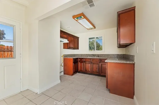 a kitchen with stainless steel appliances granite countertop a refrigerator and a stove