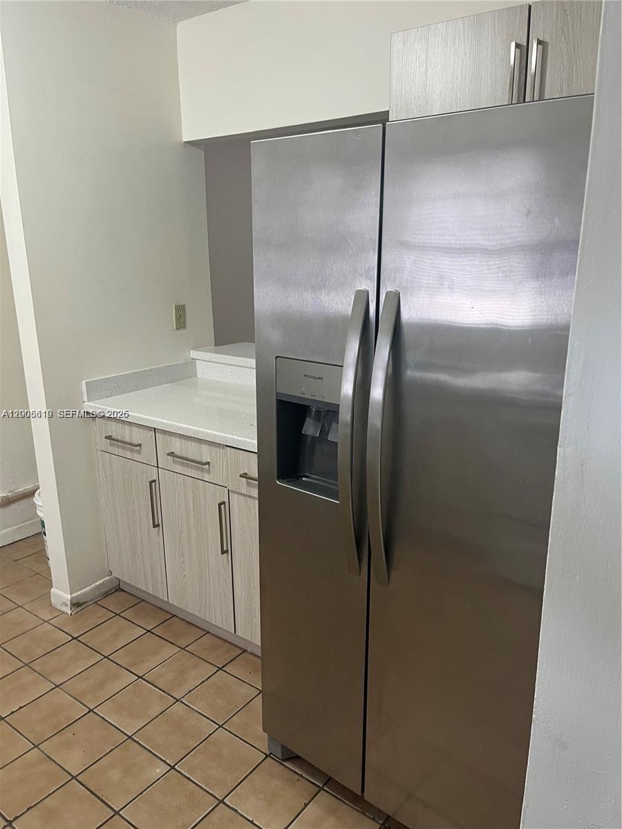 a kitchen with a refrigerator and a sink