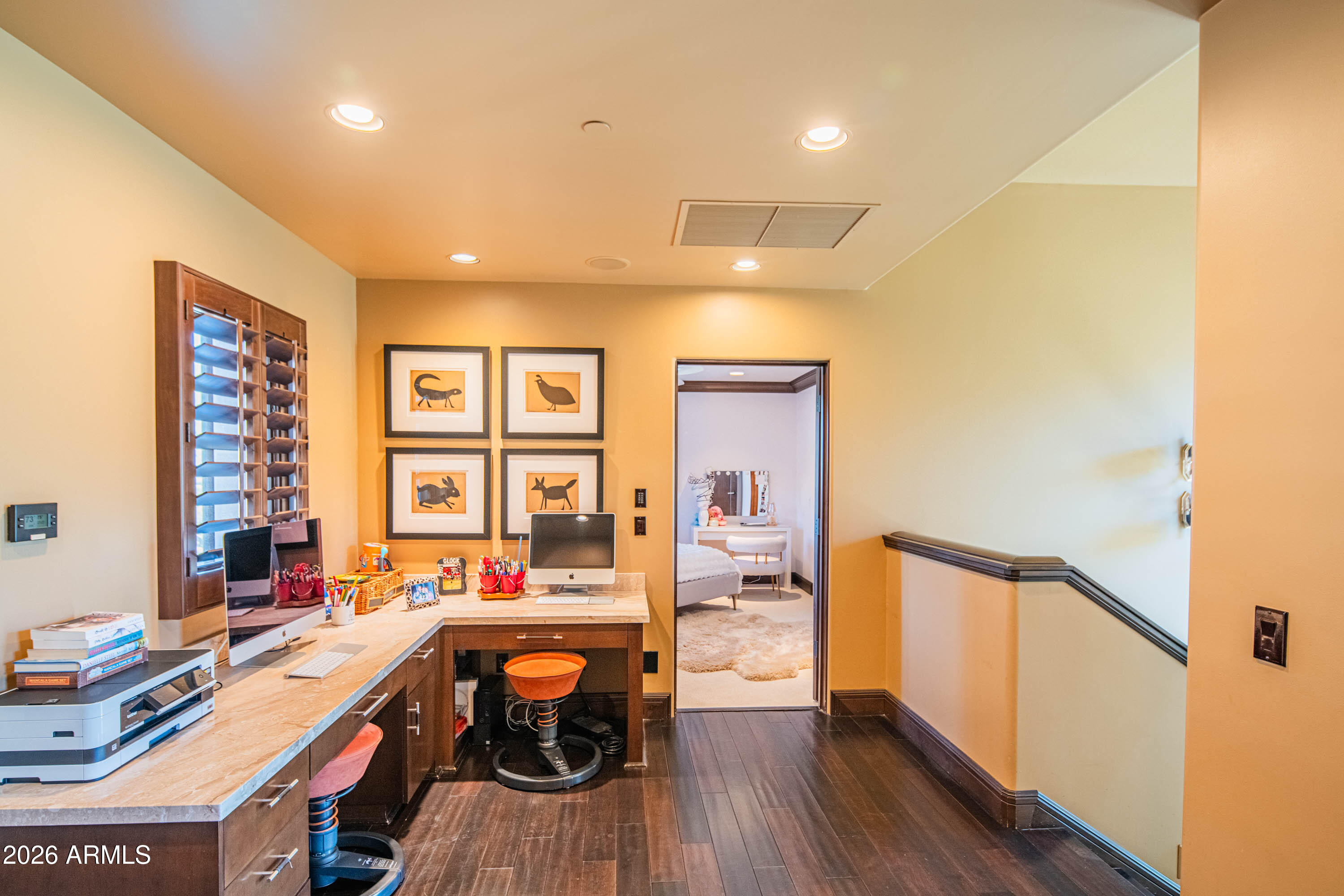 21401 West Granite Ridge Road Buckeye, AZ 85396 - Photo 104 of 144 a view of a workspace with furniture and wooden floor