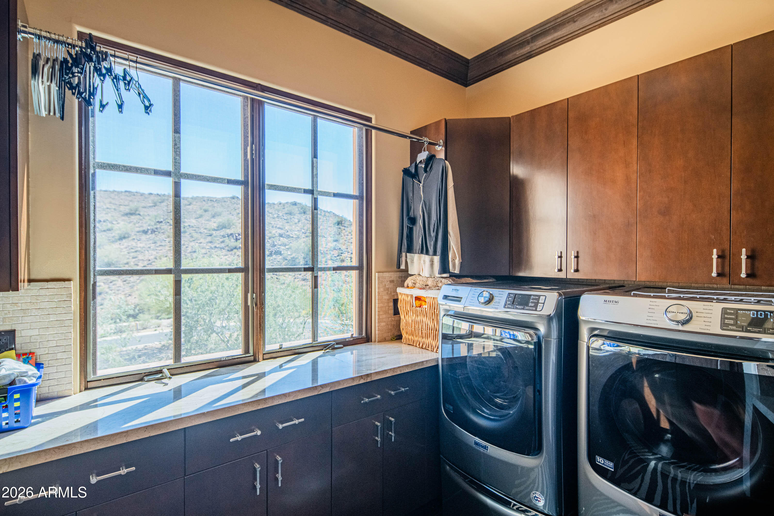 21401 West Granite Ridge Road Buckeye, AZ 85396 - Photo 112 of 144 a bathroom with a sink a washer and dryer next to a window