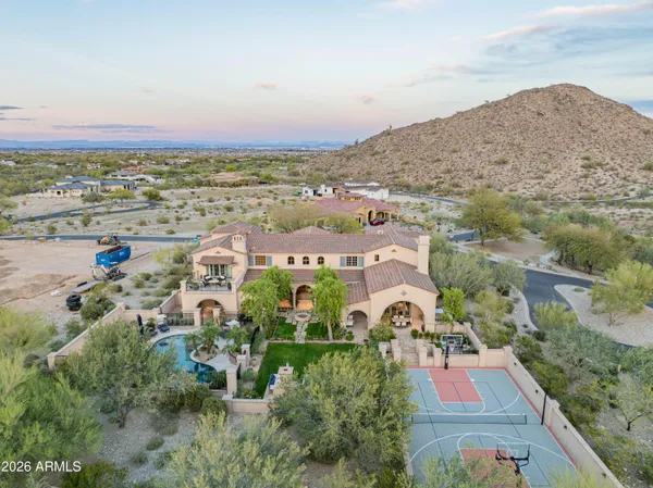 a living room with furniture a flat screen tv and a refrigerator