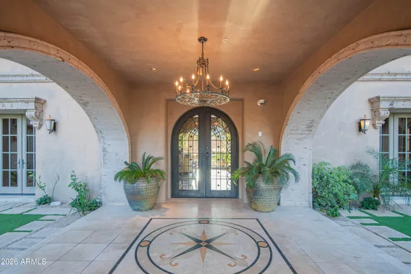a bedroom with furniture and large windows
