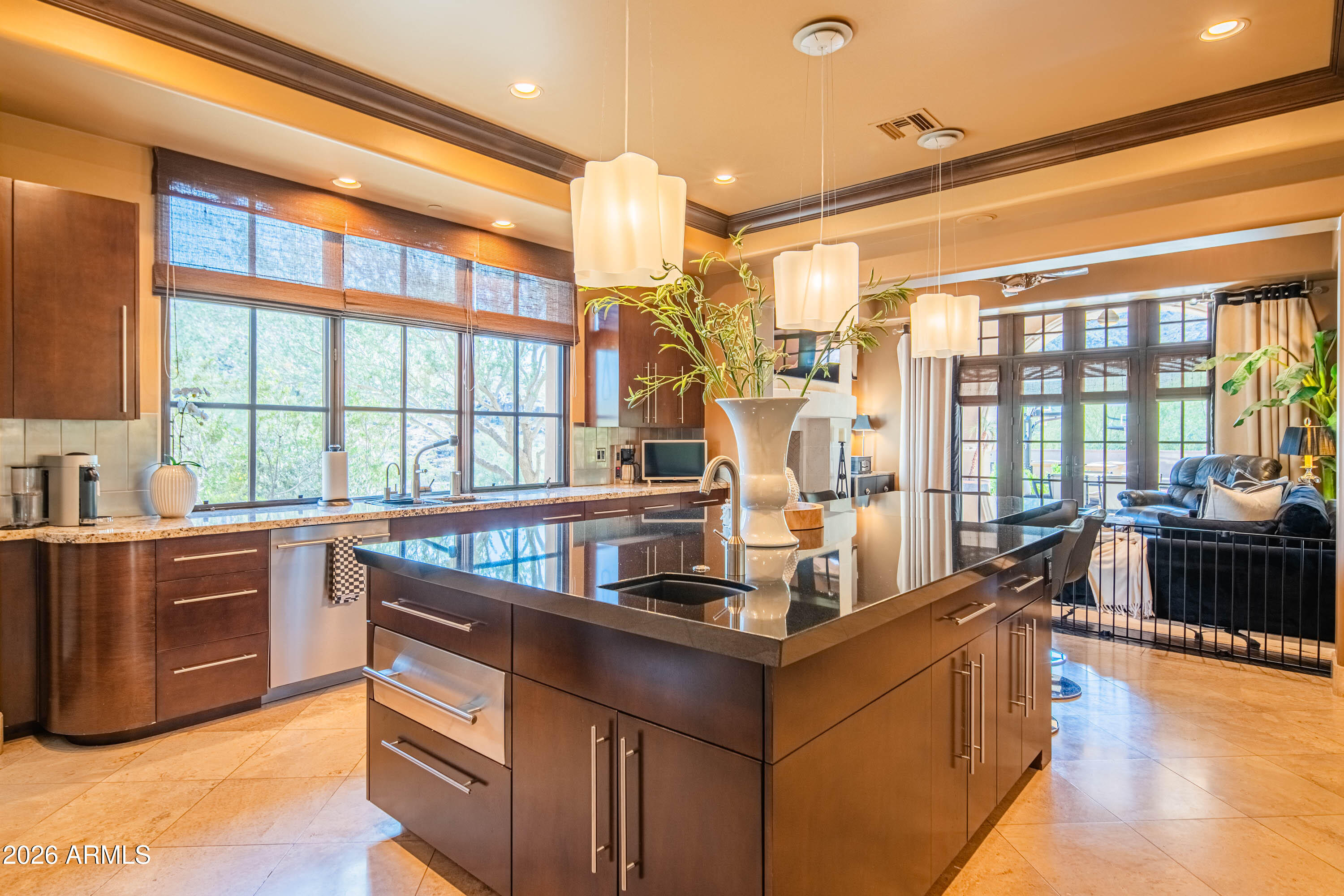 21401 West Granite Ridge Road Buckeye, AZ 85396 - Photo 27 of 144 a kitchen with kitchen island granite countertop a large window and a counter space