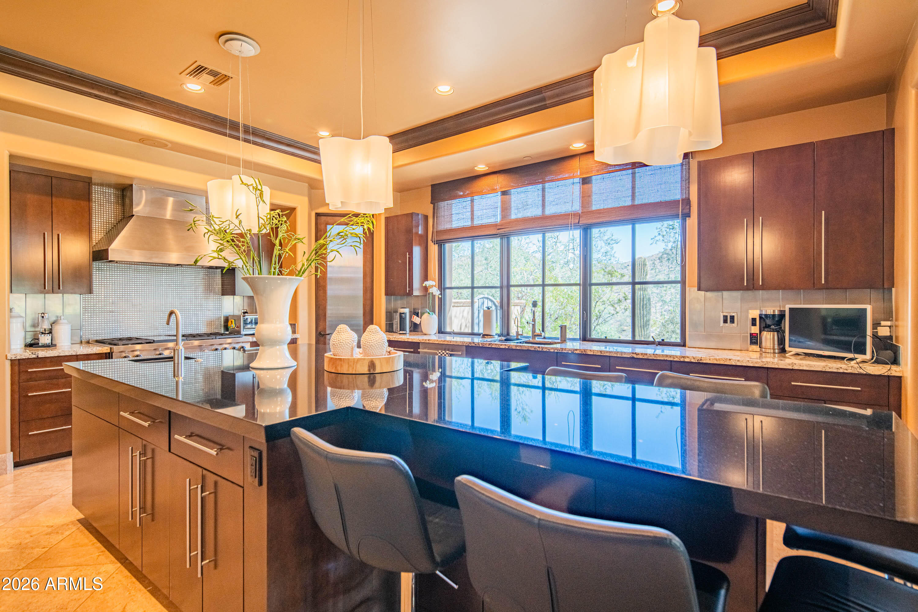 21401 West Granite Ridge Road Buckeye, AZ 85396 - Photo 28 of 144 a kitchen with stainless steel appliances granite countertop a sink a stove and a refrigerator