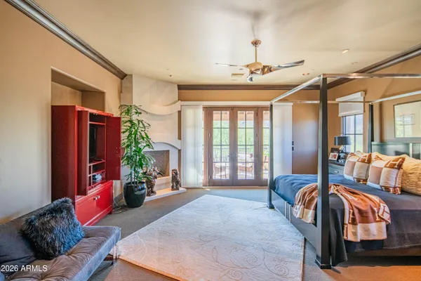 a bedroom with a large bed and a window