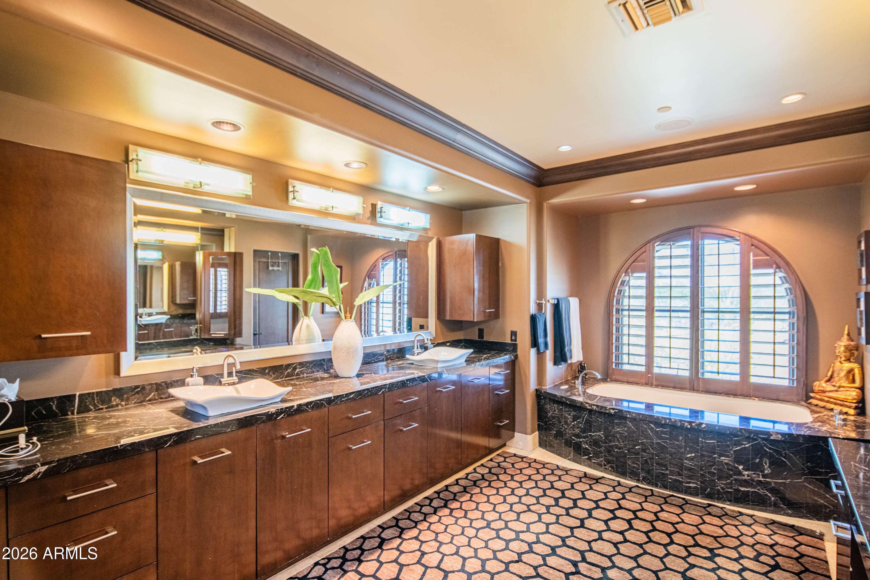 21401 West Granite Ridge Road Buckeye, AZ 85396 - Photo 50 of 144 a spacious bathroom with a sink a large mirror a bathtub and next to a window