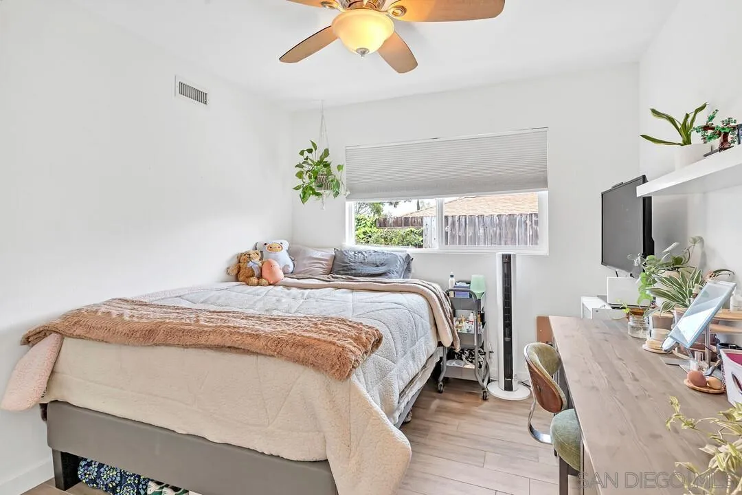 13415 Pequot Drive Poway, CA 92064 - Photo 25 of 63 a bedroom with a bed and a chandelier