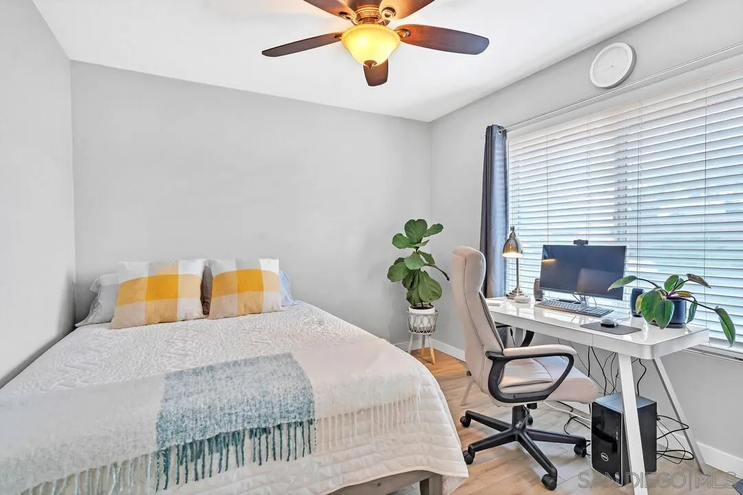13415 Pequot Drive Poway, CA 92064 - Photo 27 of 63 a bedroom with a bed a desk and chair with potted plants