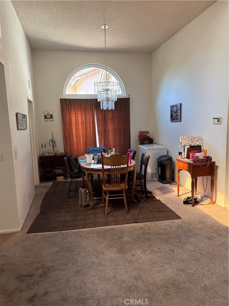 133 Cannon Road Riverside, CA 92506 - Photo 13 of 32 a view of a dining room with furniture and chandelier