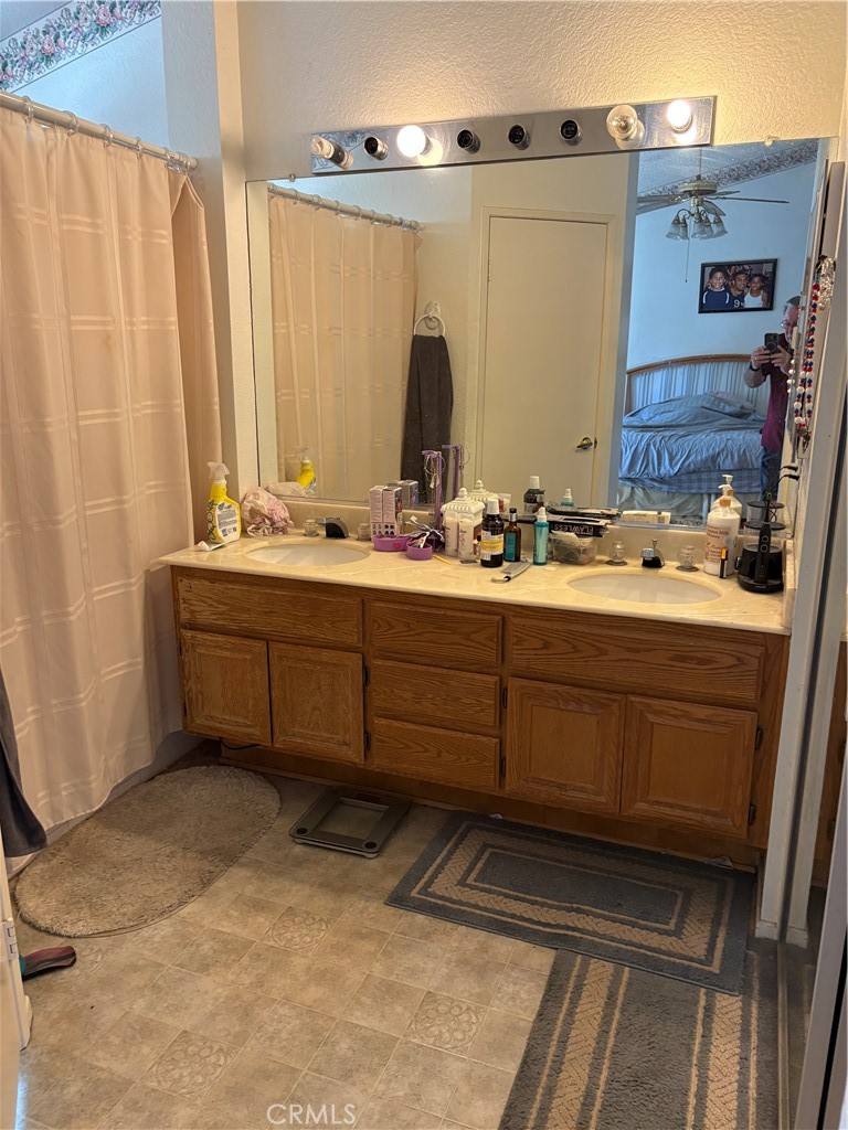133 Cannon Road Riverside, CA 92506 - Photo 17 of 32 a bathroom with a double vanity sink and mirror