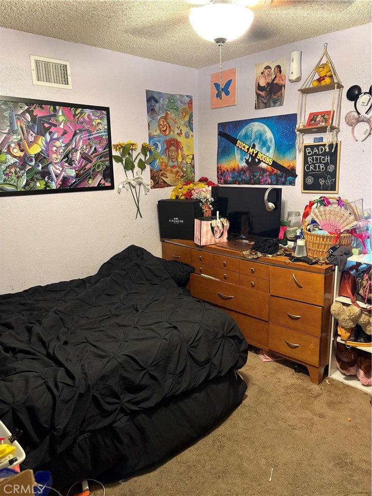 133 Cannon Road Riverside, CA 92506 - Photo 18 of 32 a bedroom with furniture and painting on the wall