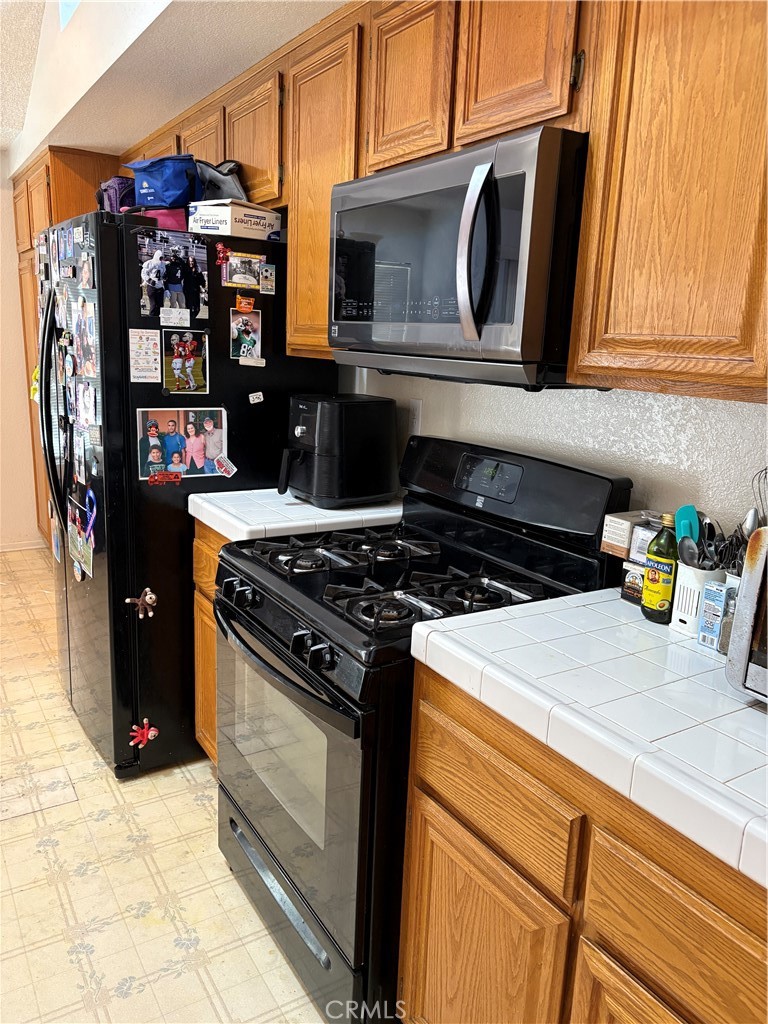 133 Cannon Road Riverside, CA 92506 - Photo 6 of 32 a kitchen with stainless steel appliances granite countertop a stove and a refrigerator