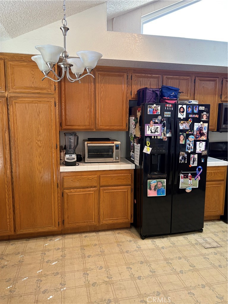 133 Cannon Road Riverside, CA 92506 - Photo 7 of 32 a kitchen with refrigerator and cabinets