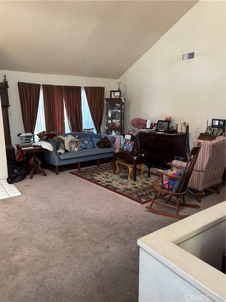 133 Cannon Road Riverside, CA 92506 - Photo 9 of 32 a living room with furniture a flat screen tv and a window