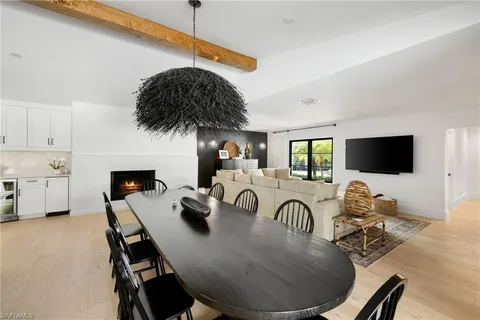 a dining room with furniture and a flat screen tv