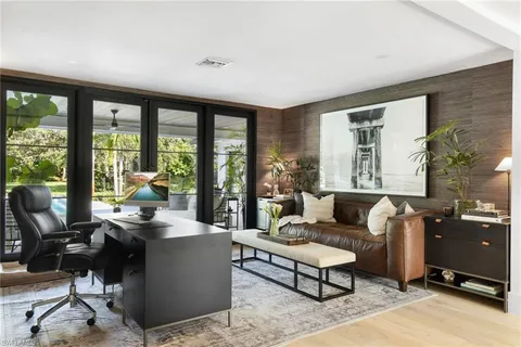 a living room with furniture and a floor to ceiling window