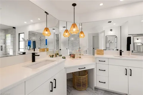 a bathroom with a sink a vanity and a mirror