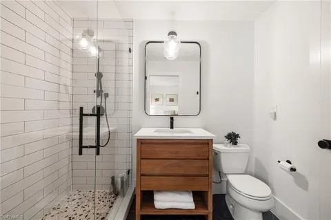 a bathroom with a sink toilet and shower