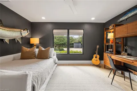 a bed room with a bed and a chair