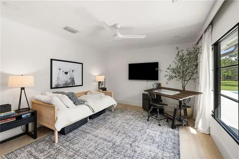 a bedroom with a bed and a flat screen tv