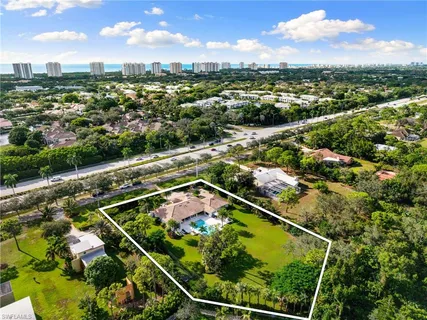an aerial view of a tennis ground and a houses