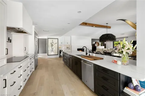 a kitchen with granite countertop a sink and cabinets