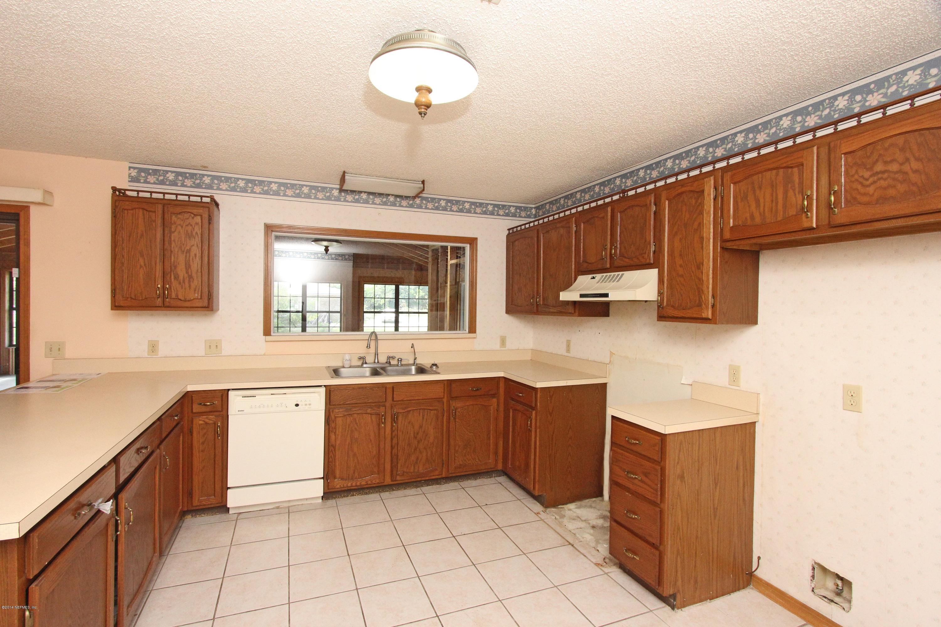 54421 Sheffield Road Callahan, FL 32011 - Photo 4 of 16 a large kitchen with stainless steel appliances granite countertop a sink and cabinets