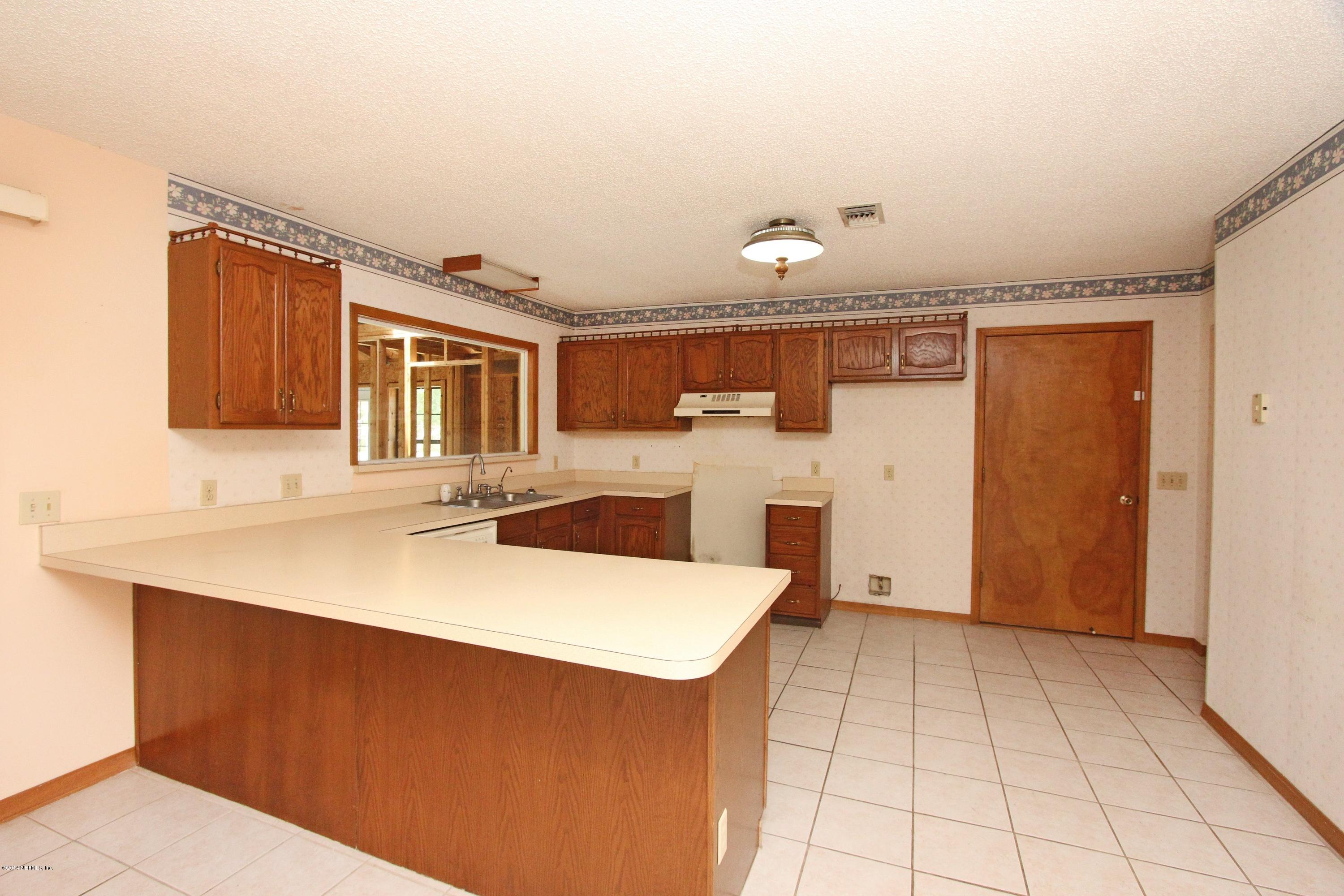 54421 Sheffield Road Callahan, FL 32011 - Photo 5 of 16 a kitchen with granite countertop a sink and cabinets
