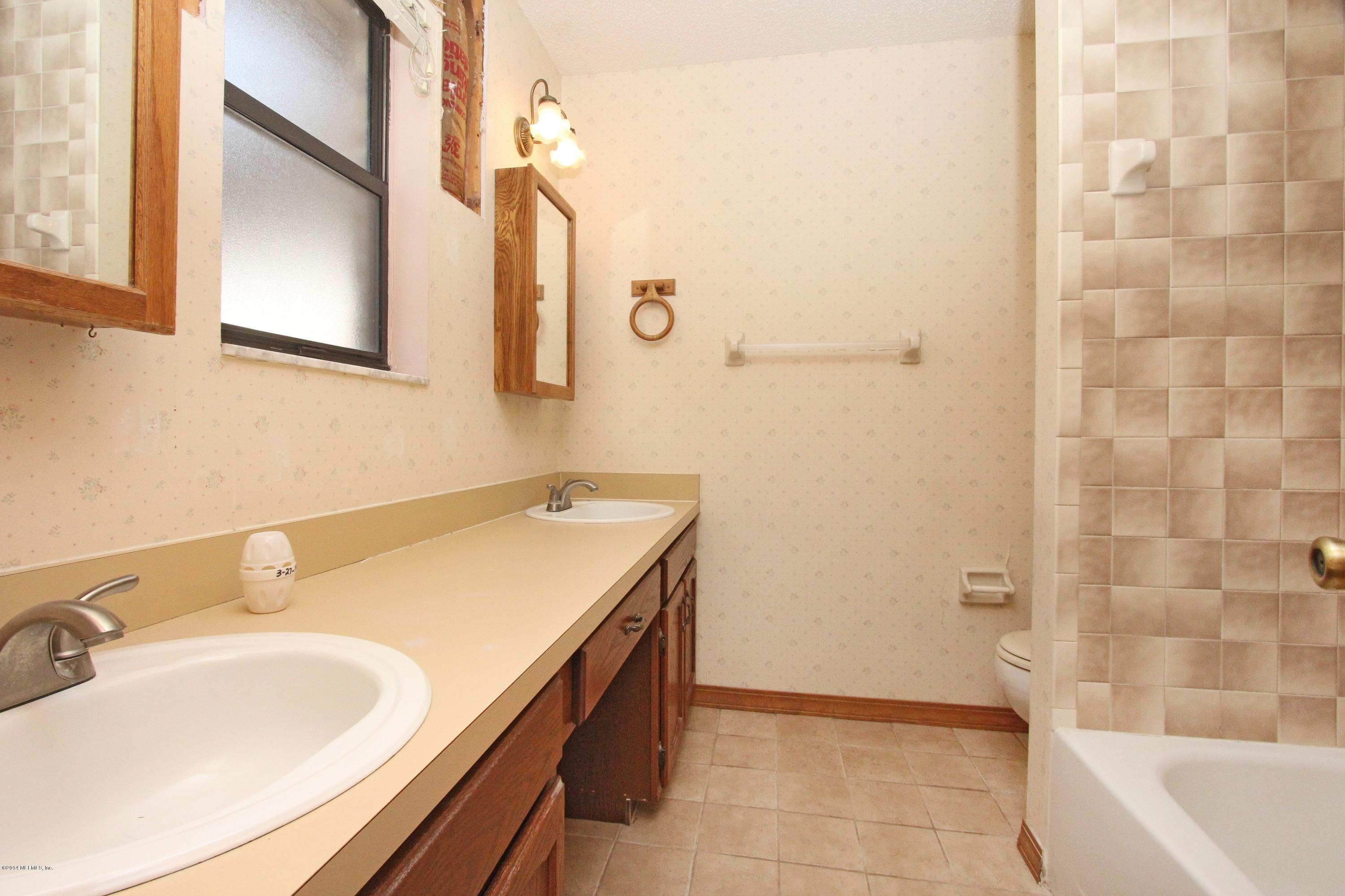 54421 Sheffield Road Callahan, FL 32011 - Photo 7 of 16 a bathroom with a sink and a mirror