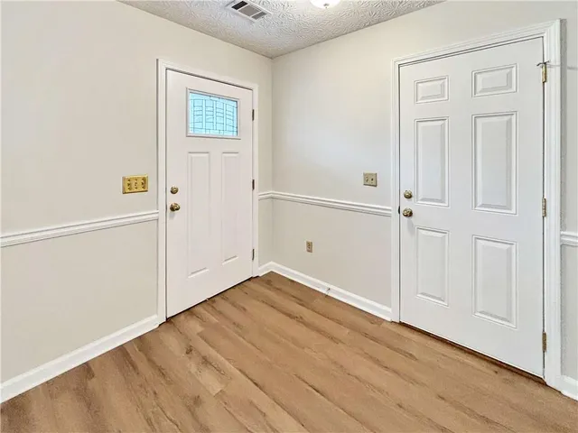 an empty room with wooden floor
