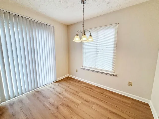 a view of a livingroom with wooden floor and a window