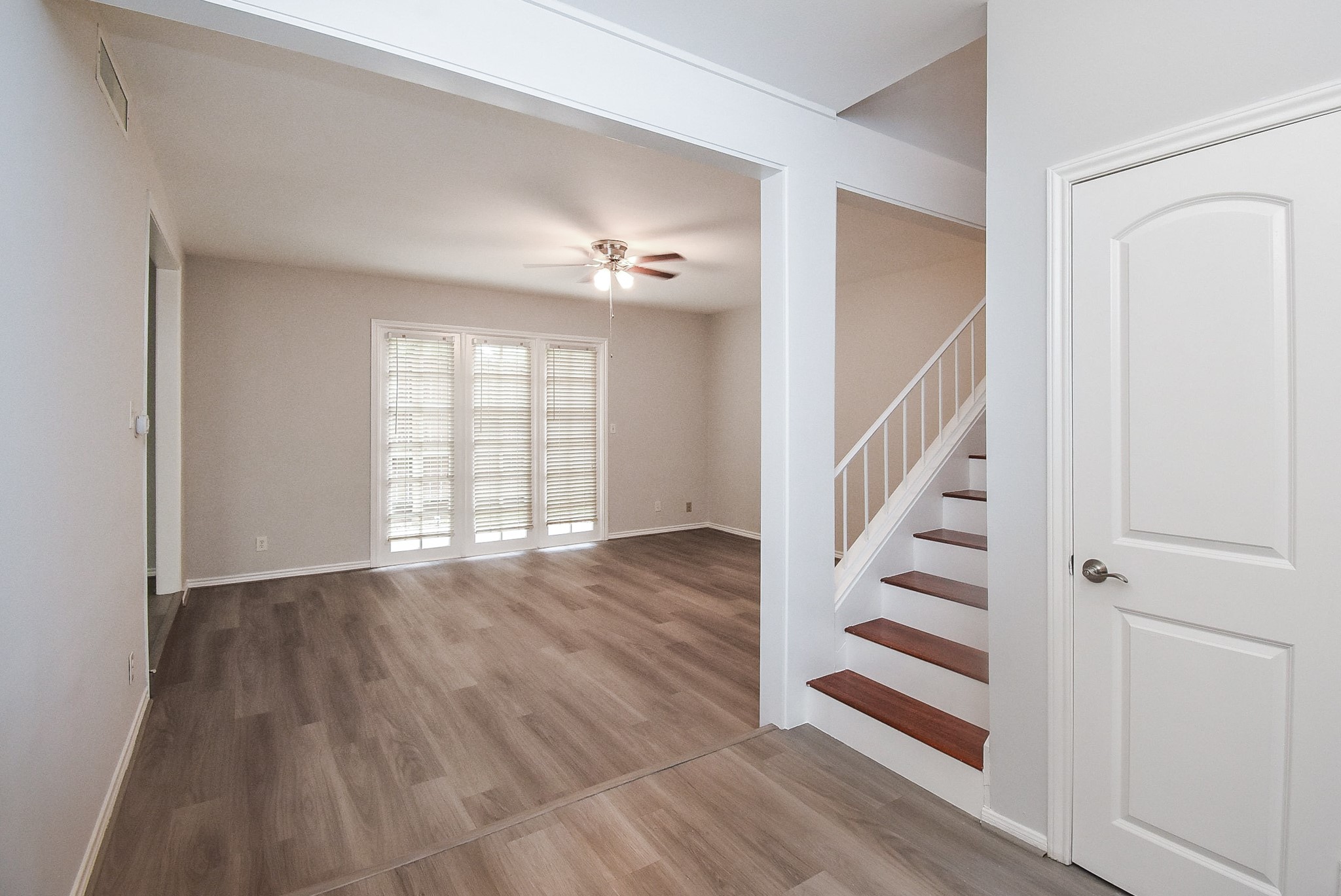 201 Vanderpool Lane, Unit 113 Houston, TX 77024 - Photo 6 of 45 a view of entryway with wooden floor and stair