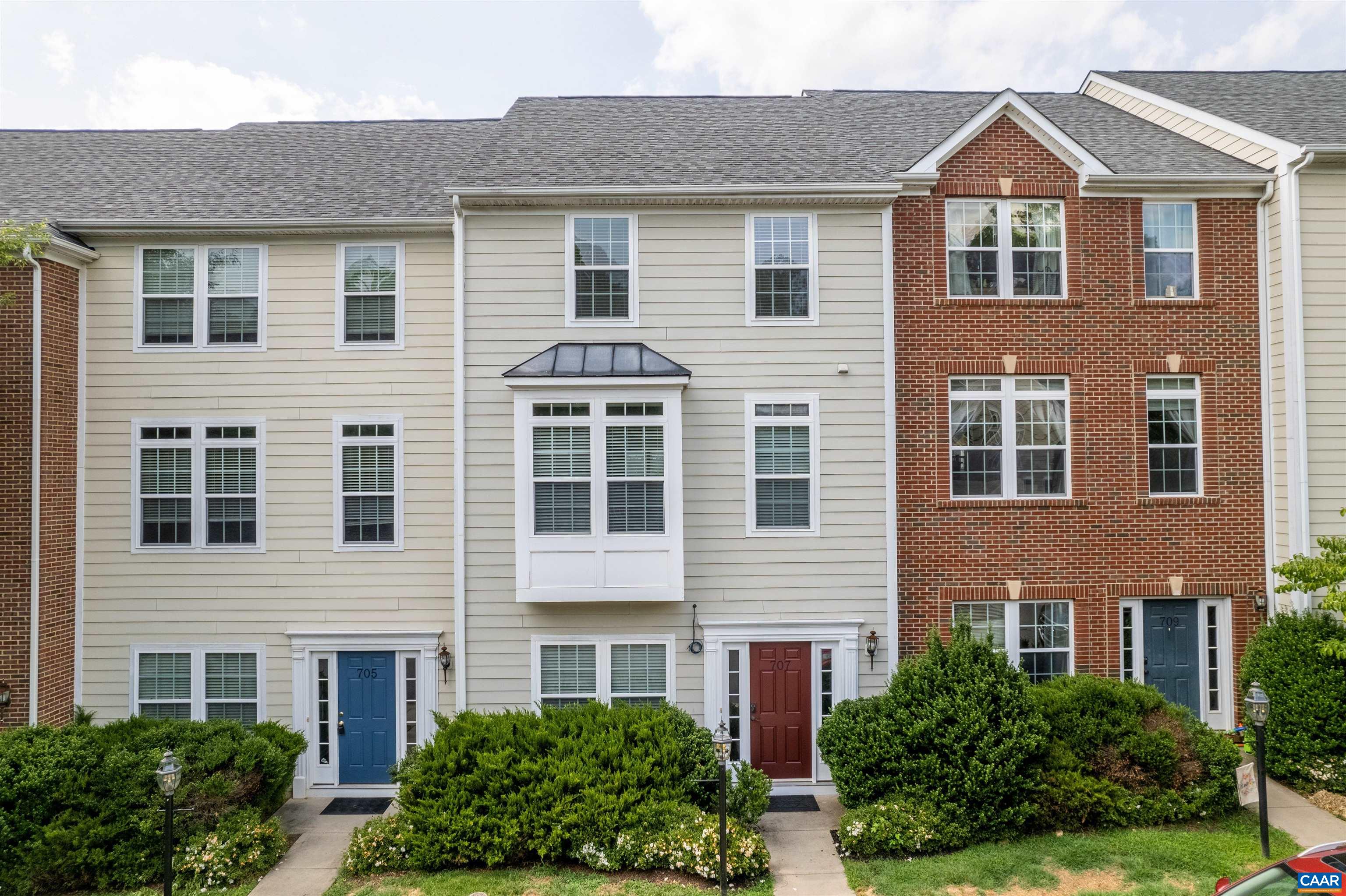 a front view of residential houses with yard