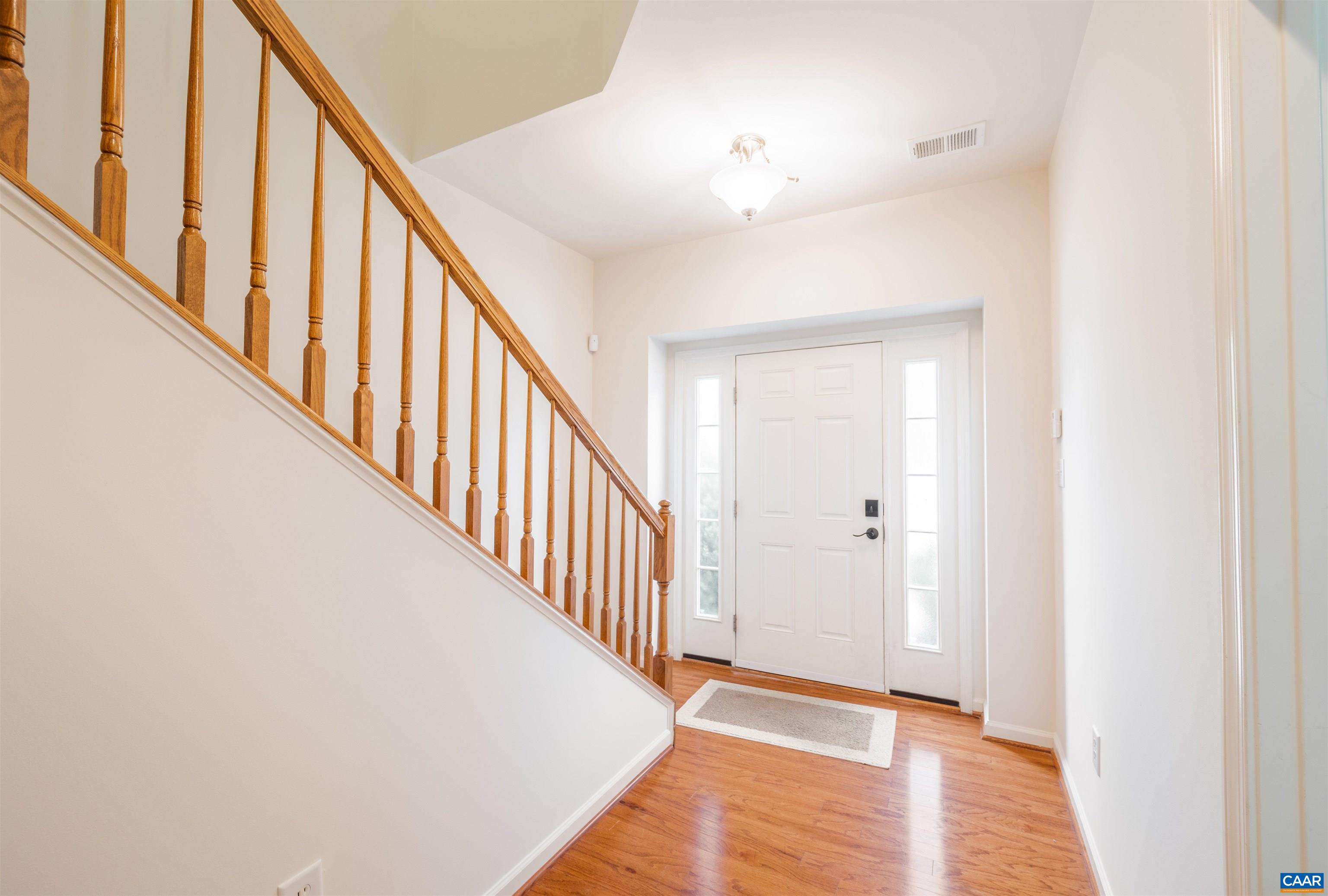 707 Rainier Road Charlottesville, VA 22903 - Photo 14 of 38 a view of a hallway with wooden floor and staircase