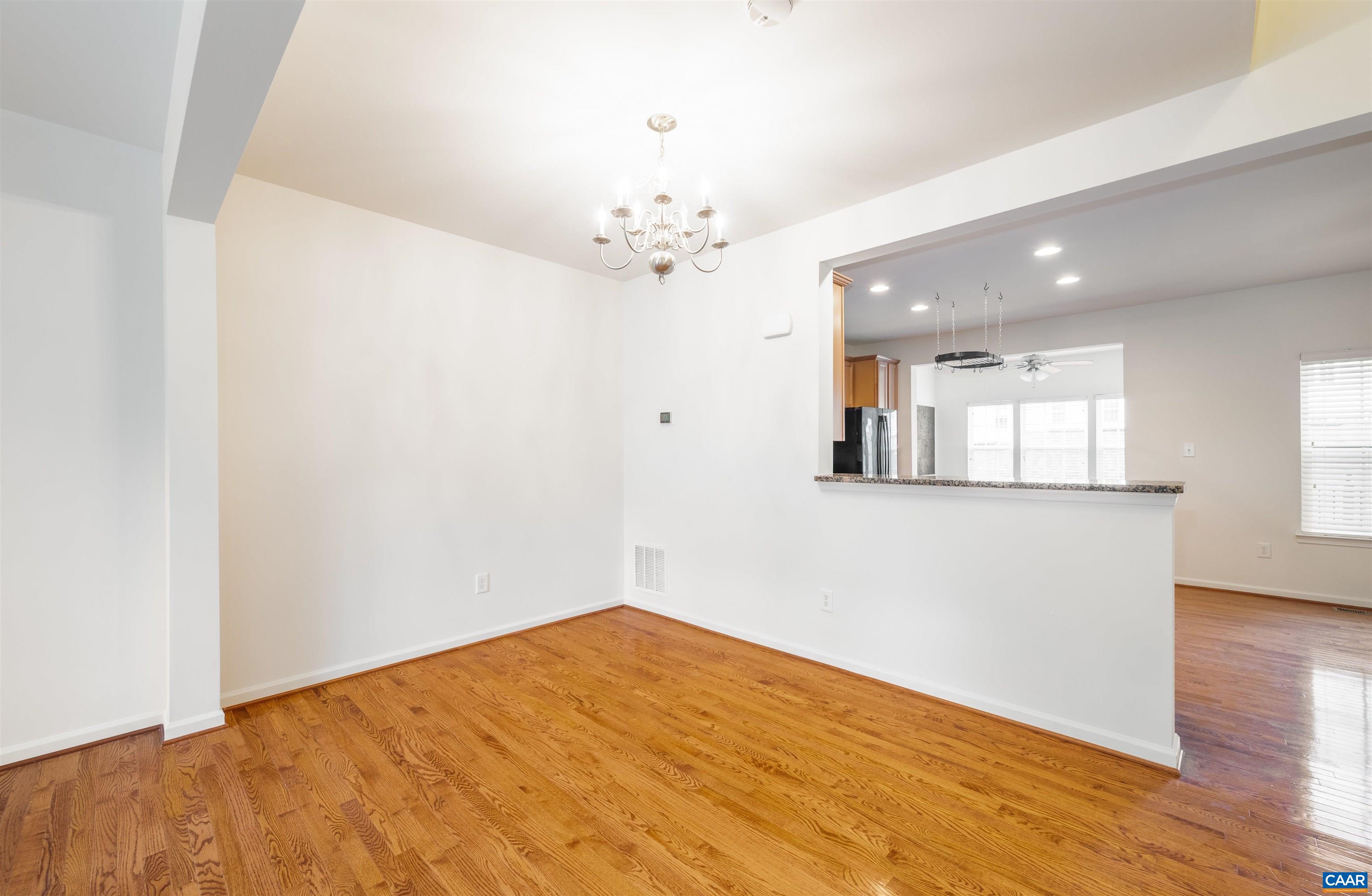 707 Rainier Road Charlottesville, VA 22903 - Photo 17 of 38 a view of a room with wooden floor and chandelier