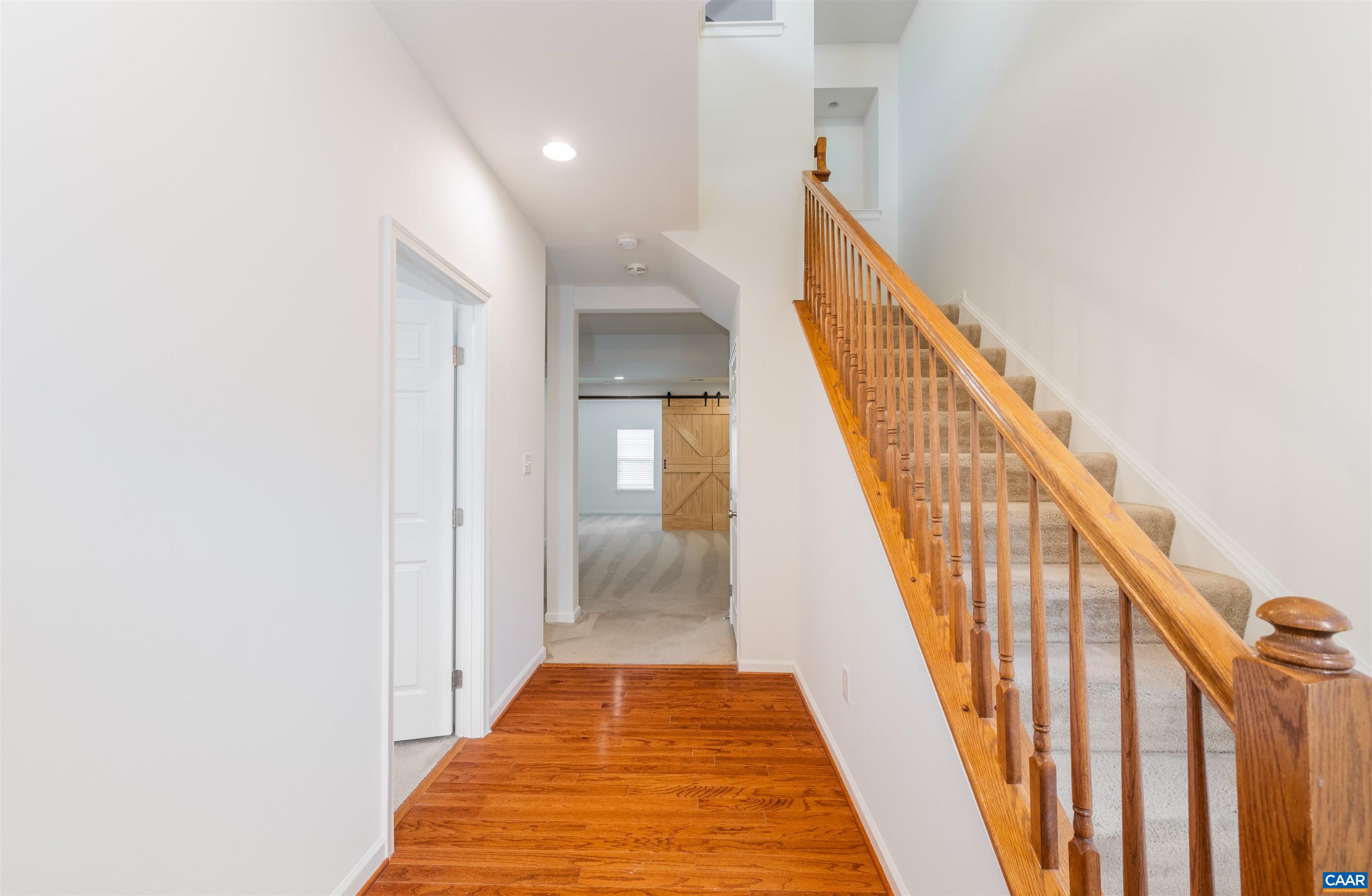 707 Rainier Road Charlottesville, VA 22903 - Photo 8 of 38 a view of a hallway with wooden floor and staircase