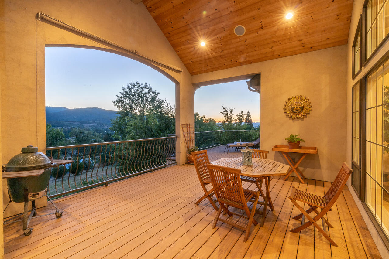 7891 Rapp Lane Talent, OR 97540 - Photo 78 of 88 a view of a patio with table and chairs with wooden floor and fence